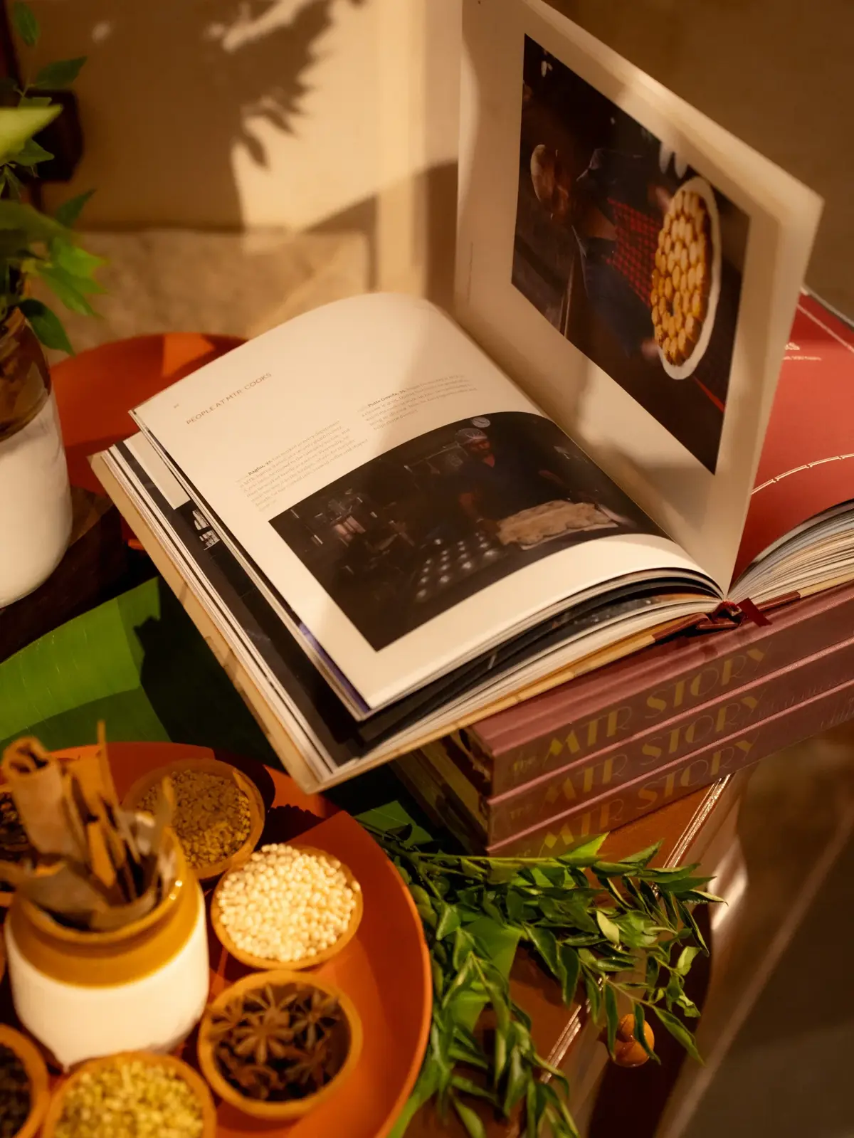 Interior spread showing food photography alongside traditional spices and ingredients