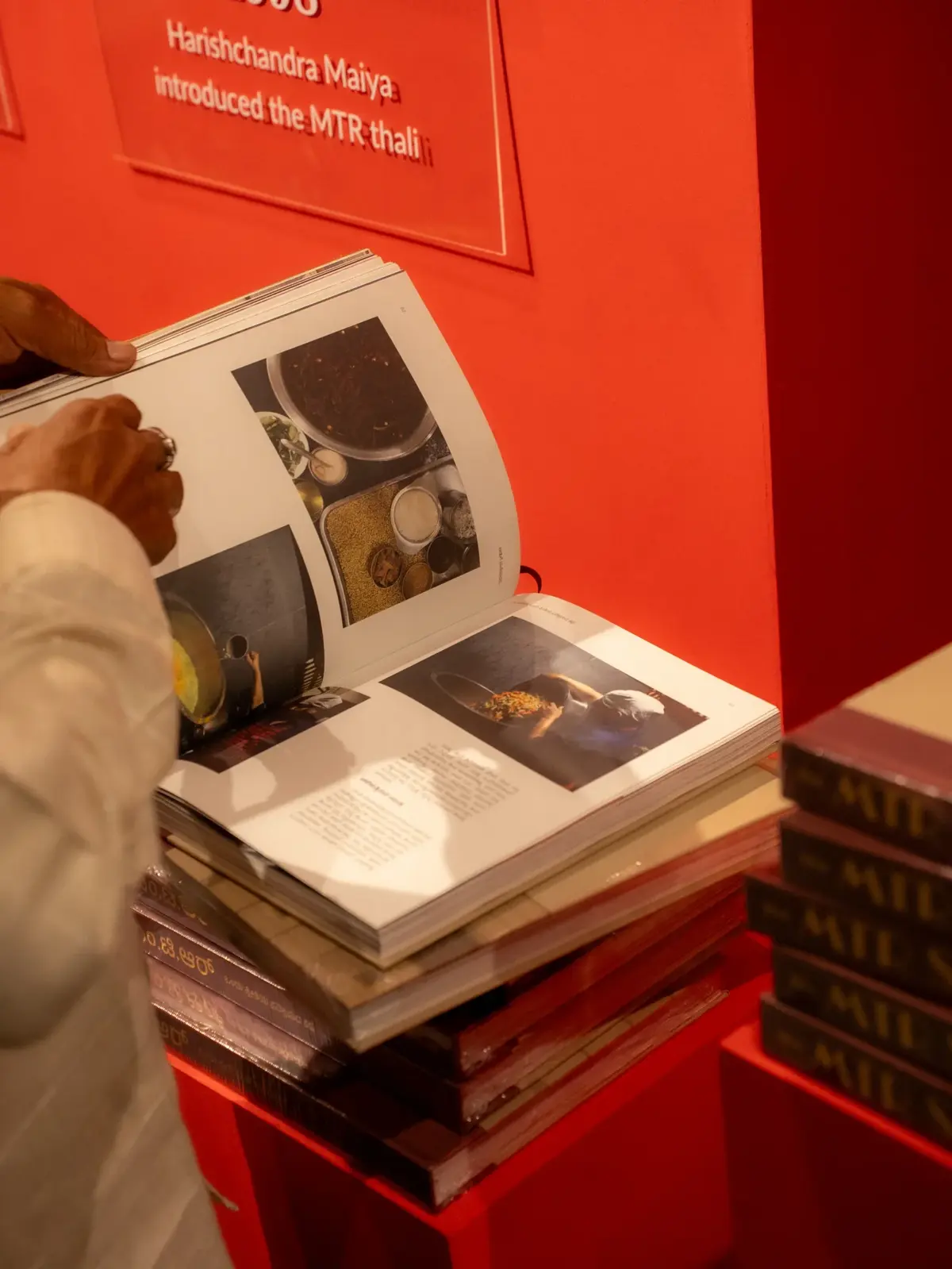 Kannada edition open to food photography spreads at a book display